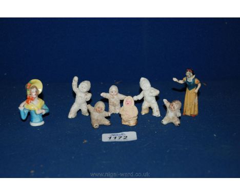 A set of Victorian ceramic Christmas decorations and a metal figure of Snow White.
