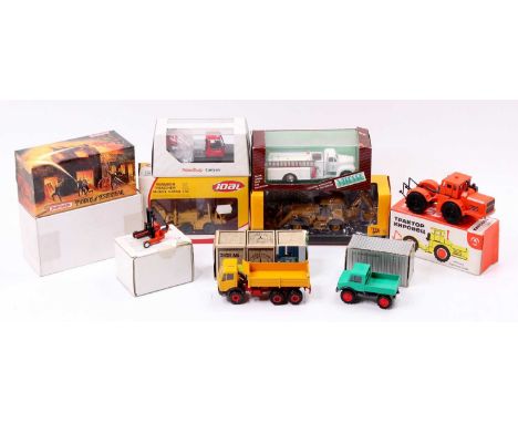 One tray contains a collection of various commercial, construction and emergency service-related diecast vehicles and accesso