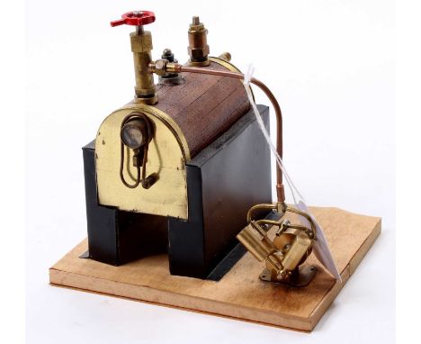 A scratch built of freelance design horizontal tin housed a horizontal boiler powering a single twin cylinder oscillating ste