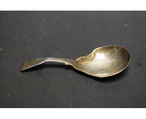 A silver caddy spoon