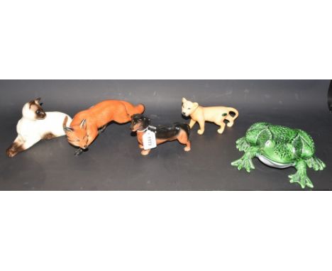 A Beswick ceramic model of a lioness; other Beswick models, Dachshund, Siamese cat; other animal models, Fox and Frog (5)