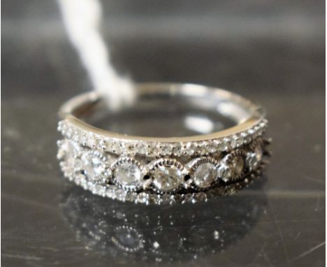 A diamond encrusted eternity ring, open crest, 9ct white gold shank, stamped 417 TGGC, 10k, size R, 3.1g gross