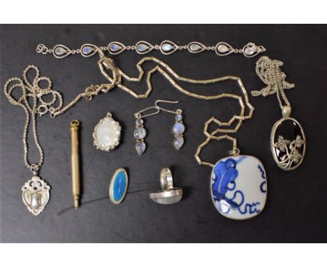 A silver and polished moonstone ring; similar earrings and bracelet; a silver and enamel brooch; a gold plated retractable pe