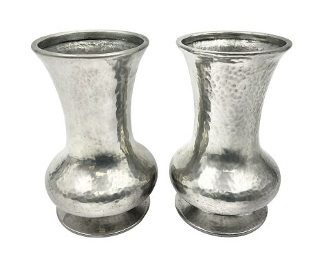 Pair of Liberty & Co Tudric pewter vases, each of bellied form with hammered finish, upon a circular spreading foot, impresse