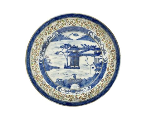 Late 19th century Chinese rice plate, of circular form decorated with underglaze blue landscape featuring figure on bridge be