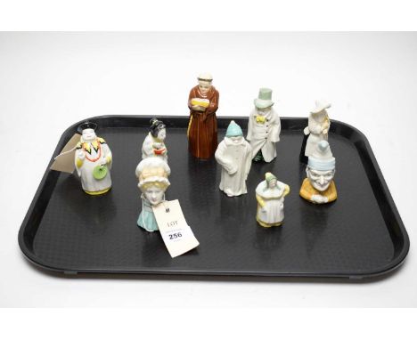A collection of Royal Worcester figural ceramic candle snuffers, including: ‘Budge’; ‘Mandarin’; ‘Japanese Girl’; Mob Cap’; ‘