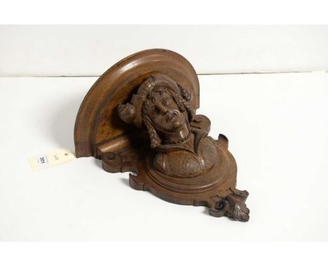 A 19th Century carved walnut corbel, with D-shaped platform shelf supported by a Renaissance style bust, with plumes in hat a