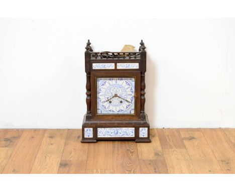 Manner of Lewis Foreman Day: an early 20th Century Aesthetic movement 8 day oak mantel clock, the blue and white ceramic face