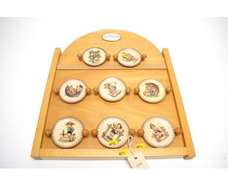 A set of eight Goebel Hummel miniature ceramic cabinet plates, each illustrating a child, 8.5cms diameter, with accompanying 