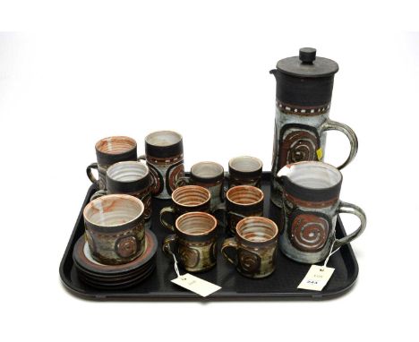 A retro 1970s style studio pottery terracotta coffee service, with pale blue glaze and swirling decoration, including coffee 