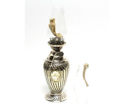 A late Victorian silver plated oil lamp, by RE&amp;S, of small proportions, with clear glass funnel, 30cms high, together wit