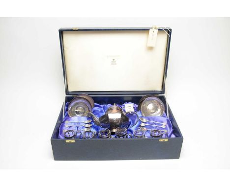 A cased silver plated tea or coffee service, by Garrard & Co, comprising pot, six glass cans with pierced silver plated holde
