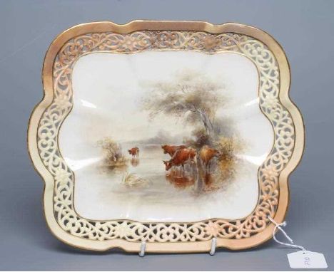 A ROYAL WORCESTER CHINA CABINET PLATE, 1905, of lobed oblong form with flowerhead and scroll pierced blush ivory rim, centred