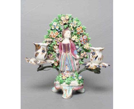 A BOW PORCELAIN FIGURAL CANDELABRUM, c.1760, modelled as a young Turkish girl wearing a puce turban and jacket over a striped
