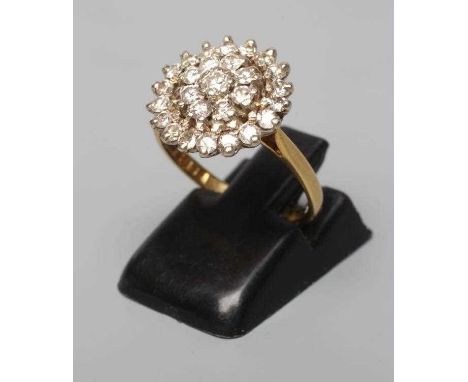 A DIAMOND CLUSTER RING, the central stone within a double border of point set stones to a plain 18ct gold shank, Birmingham 1