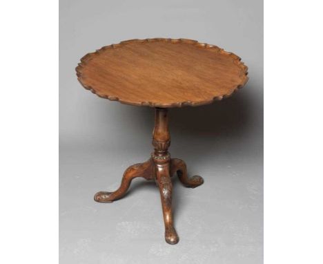 A GEORGIAN MAHOGANY TRIPOD TABLE, third quarter 18th century, the circular piecrust top with birdcage action, on baluster ste