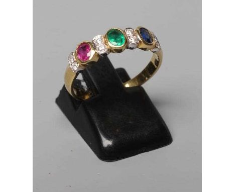 A MULTI GEM HALF HOOP RING collet set with an oval facet cut emerald, ruby and sapphire with pairs of point set small diamond