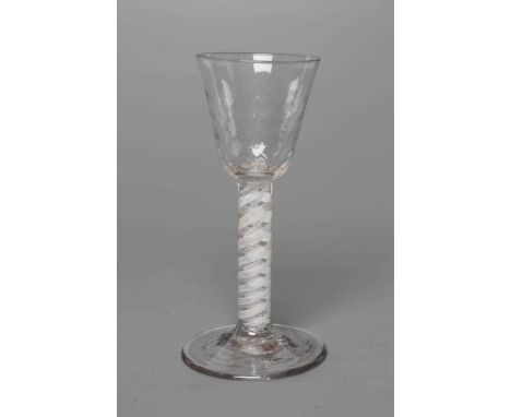 A WINE GLASS, mid 18th century, the honeycomb mould blown round funnel bowl issuing from a cylindrical opaque twist stem with