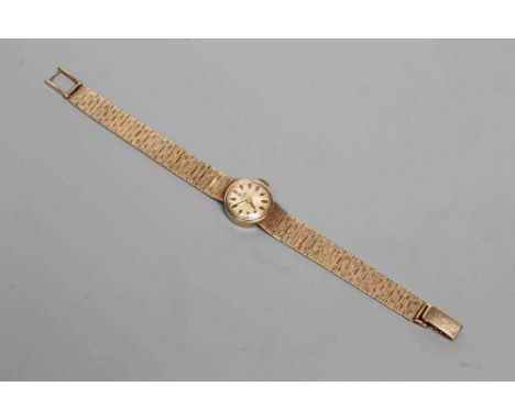A LADY'S 9CT GOLD TISSOT WRISTWATCH, the silvered dial with applied batons, un-numbered jewelled movement, in a plain case on