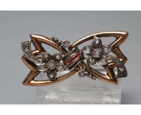 AN ART DECO DIAMOND AND RUBY BOW BROOCH, the angular loops centred by a convex row of five channel set square cut rubies flan