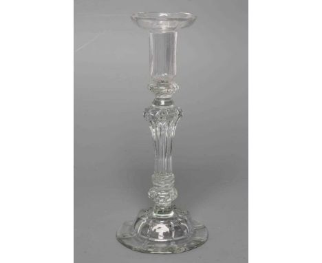 A GLASS CANDLESTICK, mid 18th century, the moulded ribbed cylindrical socket with dished drip-pan, issuing from a teared knop