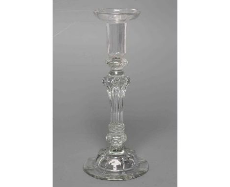 A GLASS CANDLESTICK, mid 18th century, the moulded ribbed cylindrical socket with dished drip-pan, issuing from a teared knop