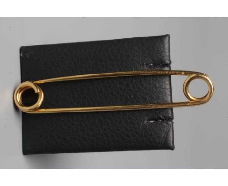 A CARTIER KILT PIN of simple twisted wire with a loop to each end, one forming the clasp, engraved Cartier, Paris in script a