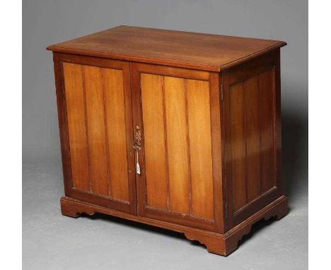 A VICTORIAN MAHOGANY DOCUMENT CABINET of panelled oblong form in the Aesthetic taste, the moulded edged top over two doors en