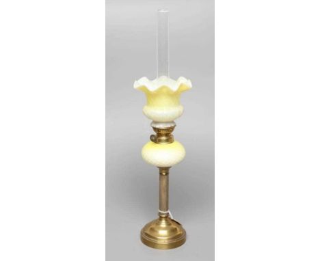 A SMALL VICTORIAN BRASS OIL LAMP, the yellow and white satin glass ball shaped shade and reservoir with air trap cross hatchi