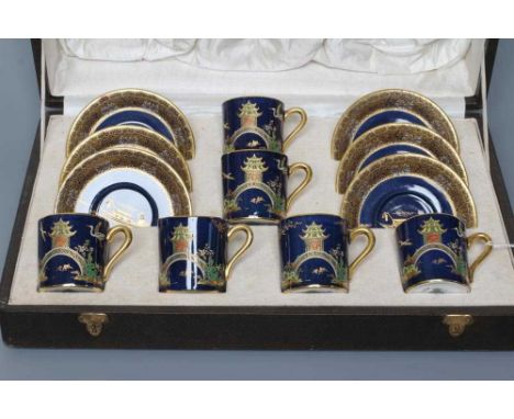 A CARLTON WARE COFFEE SERVICE, 1930's, printed and painted in typical colours with a chinoiserie landscape on a dark powder b