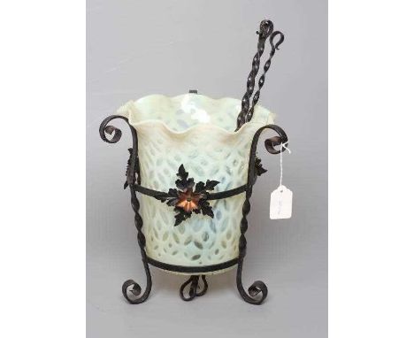AN ART NOUVEAU WROUGHT IRON LANTERN, the wrythen turned frame with three applied anodised copper flowerheads, supporting a ye