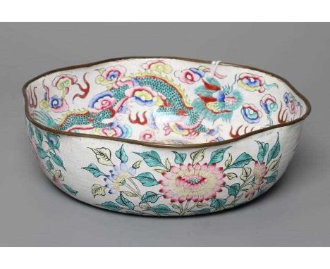 A CANTON ENAMEL BOWL of lobed circular form, painted in bright colours with dragons on a white ground, unmarked, 8" diameter 