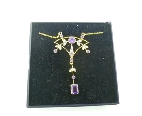 AN ART NOUVEAU STYLE AMETHYST AND DIAMOND GOLD COLOURED METAL PENDANT fashioned with stylised leaves on gold coloured metal c