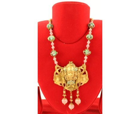 AN ART NOUVEAU STYLE NECKLACE with applied lampwork beads and gilt metal mask pendant 