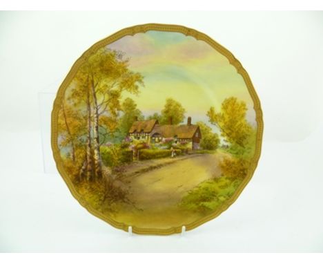 A ROYAL WORCESTER PORCELAIN CABINET PLATE hand painted by R Rushton with a scene of Anne Hathaway's cottage, Stratford-upon-A