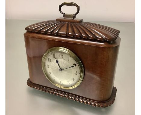 A French walnut-cased mantel clock, early 20th century, of caddy form, the case with domed reeded top and brass handle, enclo