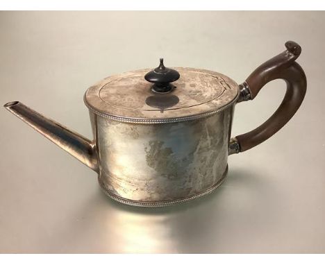 A George III silver teapot, Charles Aldridge &amp; Henry Green, London 1779, of oval drum form, with wooden scroll handle and