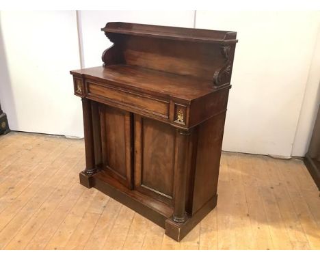 A George IV mahogany chiffonier, the raised back with three quarter gallery and scrolling truss supports, above a panelled fr