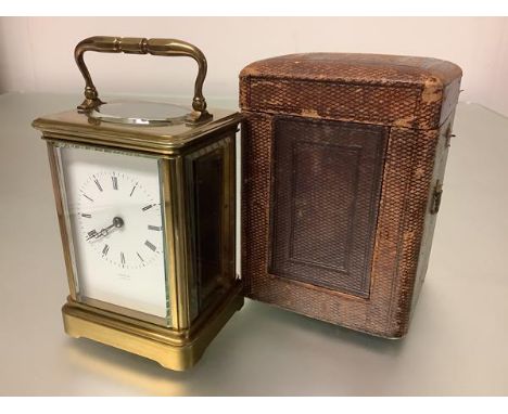 A French 19th century brass-cased carriage clock, the eight day movement within a plain brass case enclosing a white enamel d