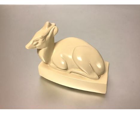 John Skeaping for Wedgwood, a model of a duiker, the faun modelled seated on a shaped rectangular base, cream-glazed, impress