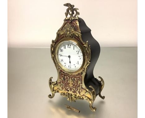 A French boulle-work mantel clock, in the Louis XV taste, c. 1900, the white enamel dial with Arabic numerals bearing retaile