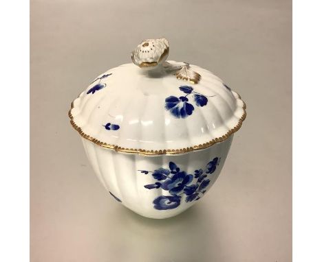 An 18th century porcelain sucrier, the domed fluted cover with floral knop over a fluted body, enamel painted throughout with