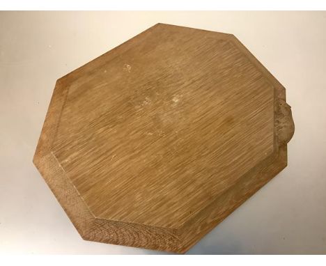 Workshop of Robert (Mouseman) Thompson, a shaped octagonal oak cheese or bread board, with carved mouse signature. 30.5cm by 