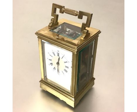 A French 19th century brass-cased repeater carriage clock, the eight day movement striking the hour and half hour on a gong, 