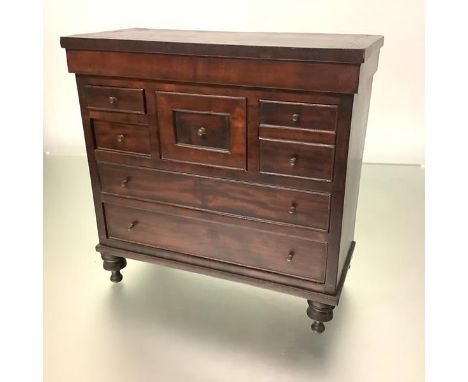 A miniature "Scotch" chest, late 19th century, with string-inlaid crossbanded top over an arrangement of drawers, raised on t
