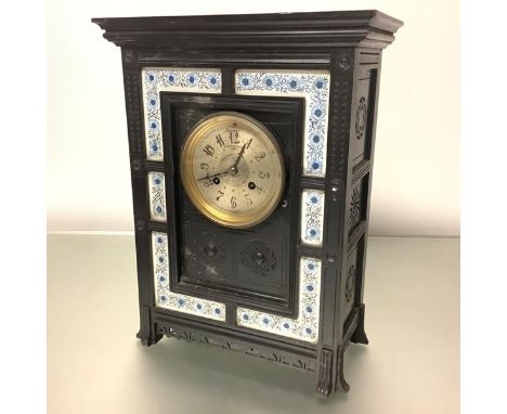 An Aesthetic Movement mantel clock, last quarter of the 19th century, the ebonised case of architectural form enclosing a sil