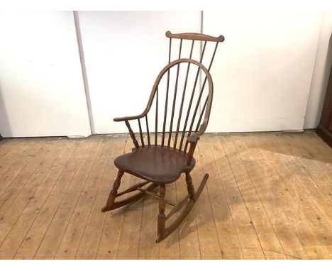 A 19thc cherrywood American Shaker style hoop and comb back rocking chair, on turned supports united by H stretcher (116cm x 