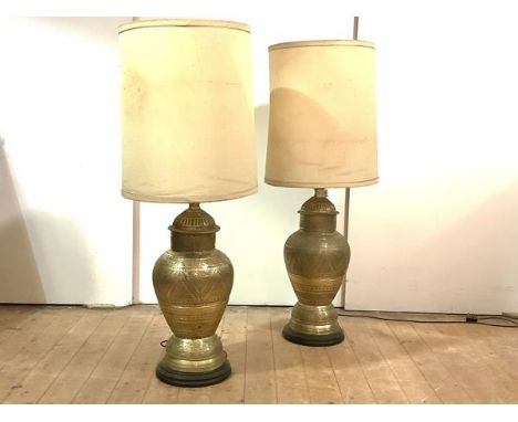 A pair of modern large Eastern style brass lamp bases, of baluster form, with scroll bands within serrated borders, raised on