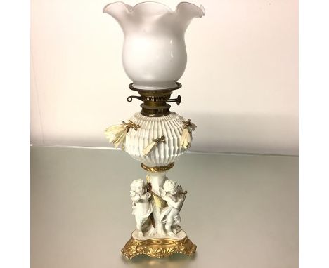 A Moore Brothers porcelain oil lamp, late 19th century, the reservoir moulded and modelled with cactus flowers on a stem form