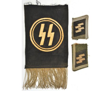 A section cut from the collar of a Third Reich SS NCO’s tunic, with wool embroidered SS runes collar patch and silver tresse,